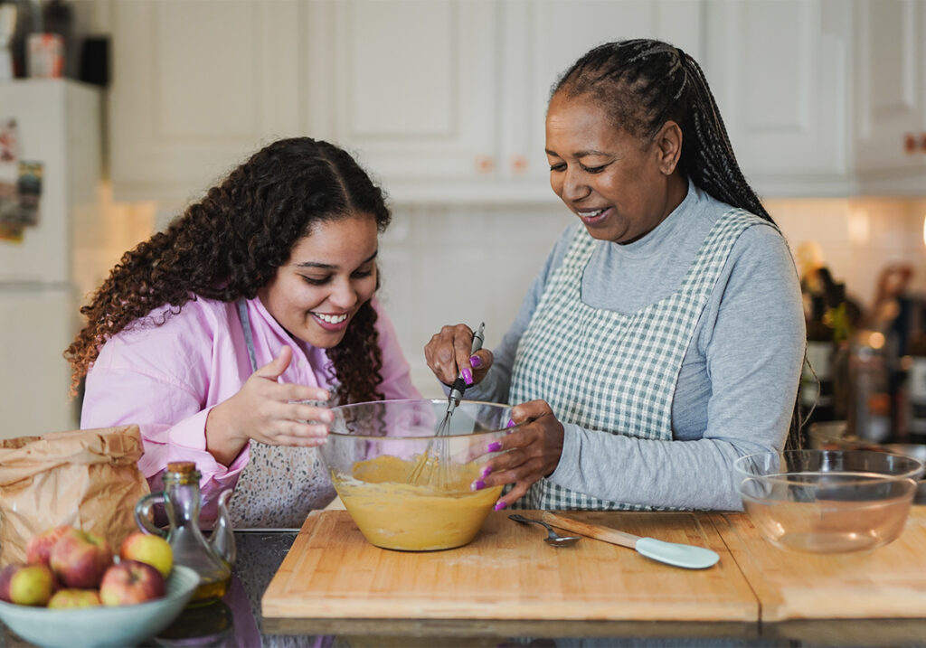 Senior Medicare patient cooking a healthy meal with family member to support diabetes management