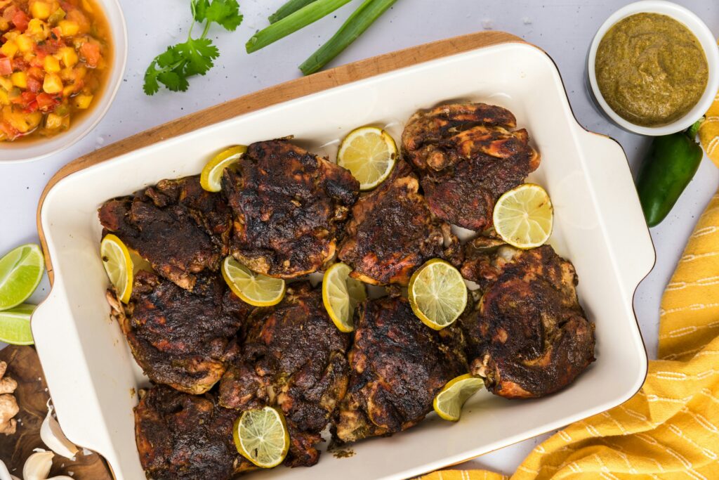 Grilled jerk chicken, a good Jamaican food choice for diabetics, served with lime and mango salsa