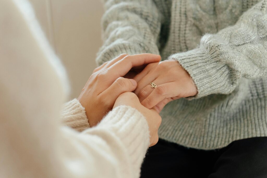 Senior holding hands with caregiver, representing emotional support and mental health care covered by Medicare