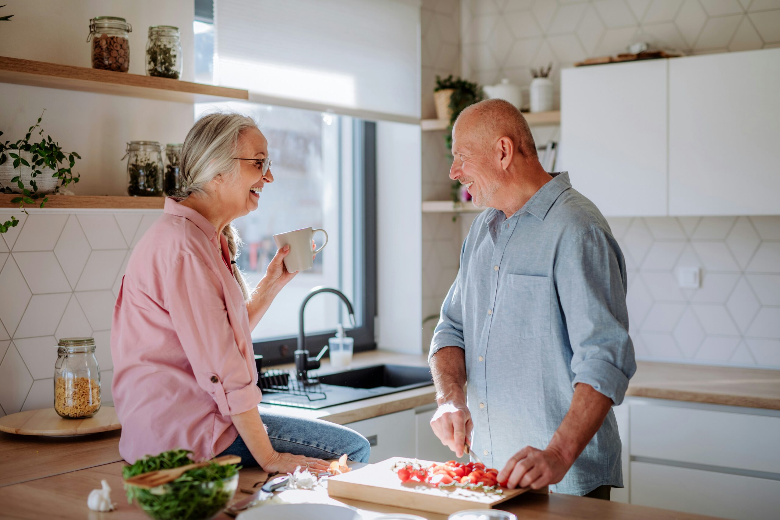Husband and wife cooking together in the kitchen while managing diabetes as a couple