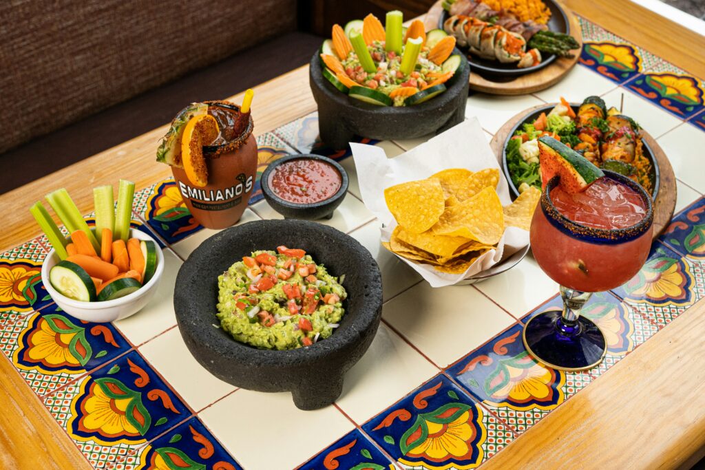 Mexican food spread with guacamole, chips, salsa, and fresh vegetables, a guide to Mexican food for diabetics