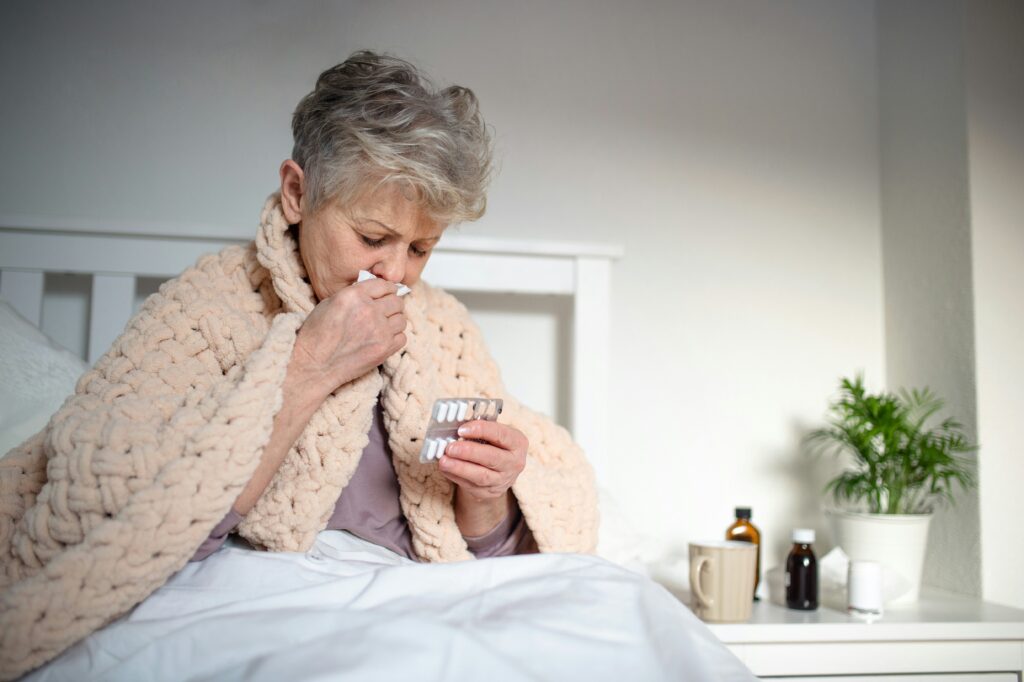 Older adult woman with COPD symptoms coughing at home showing how humidity worsens COPD