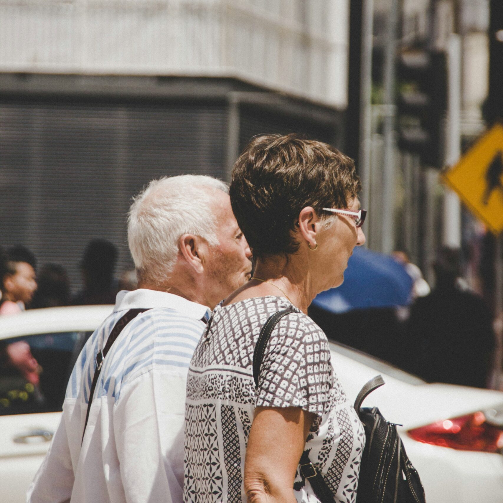 Two elderly New Yorkers walking together on a city street, representing POD Health's Medicare chronic care management community in New York State