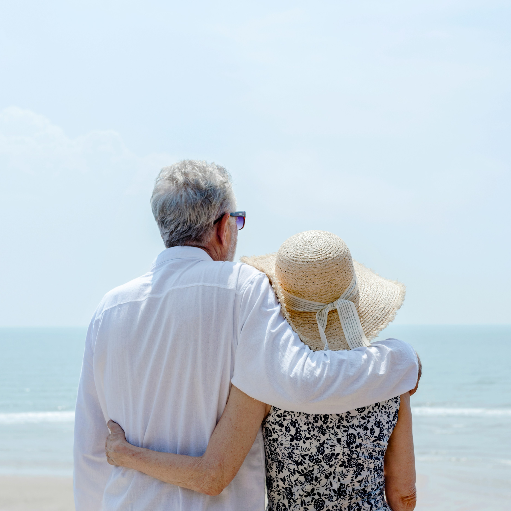 Elderly couple embracing while looking at the ocean in Florida, for POD Health's Medicare chronic care management